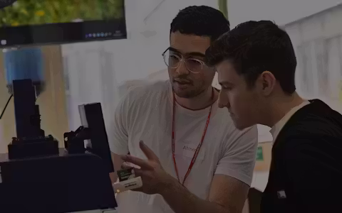 Cardiff University ambassador showing an open day attendee how to use specialist equipment
